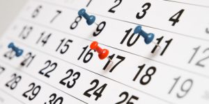 Closeup calendar page with drawing pins